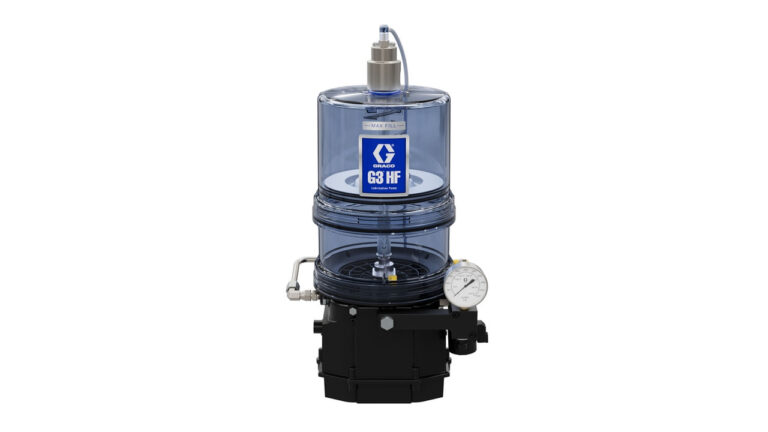 A clear cylindrical industrial pump with a blue label reading Graco G3 HF, a pressure gauge, and various pipes and fittings attached to a black base.