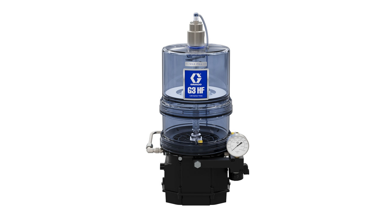 A clear cylindrical industrial pump with a blue label reading Graco G3 HF, a pressure gauge, and various pipes and fittings attached to a black base.